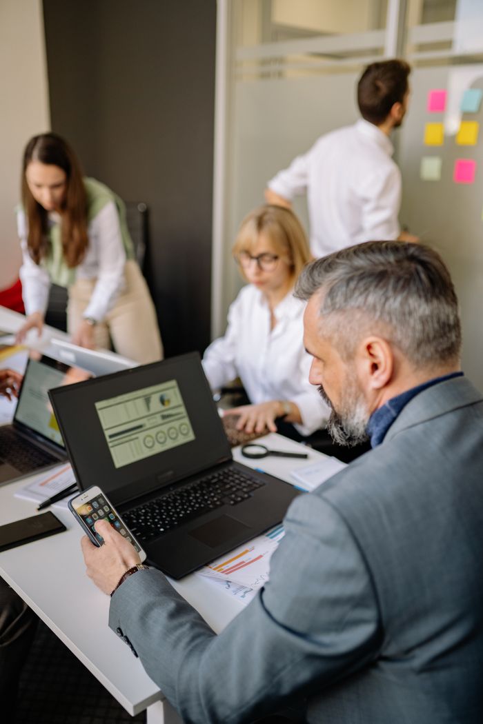 home-img Corporate team working together with technology in a modern office setting, promoting collaboration and productivity.